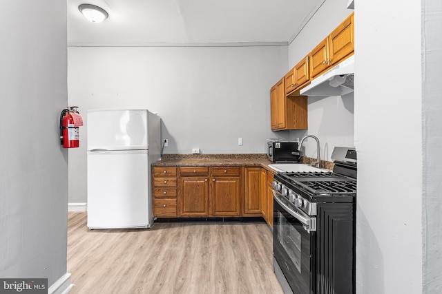 840 Cumberland St, Gloucester City, NJ 08030 - kitchen with stainless steel appliances, a sink, under cabinet range hood, and brown cabinets