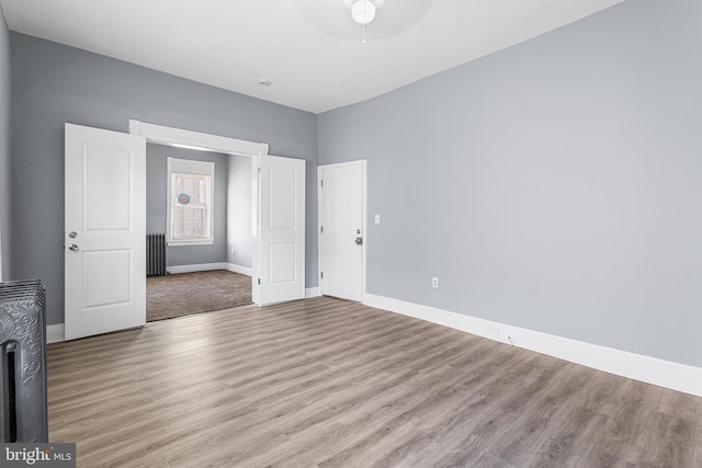 840 Cumberland St, Gloucester City, NJ 08030 - unfurnished room with radiator heating unit, a ceiling fan, wood finished floors, and baseboards