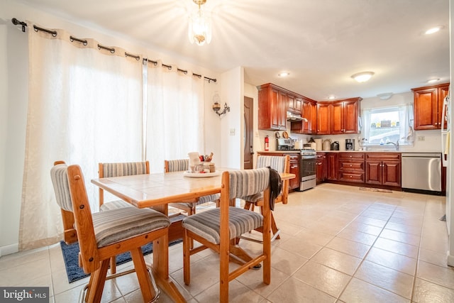 dining space with light tile patterned floors and recessed lighting