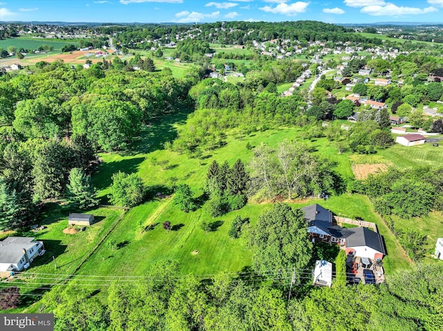 aerial view of property's location with a tree filled landscape