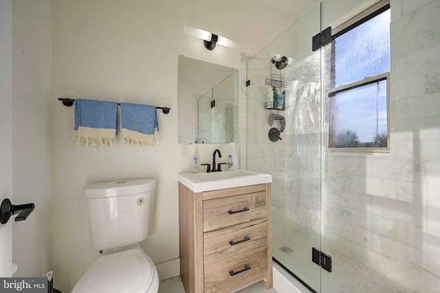 bathroom featuring vanity, toilet, and a stall shower