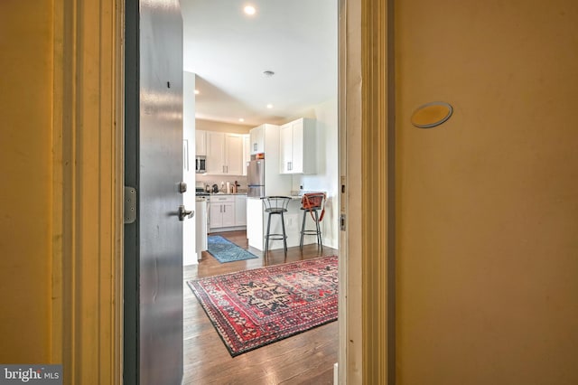 hall featuring recessed lighting and wood finished floors