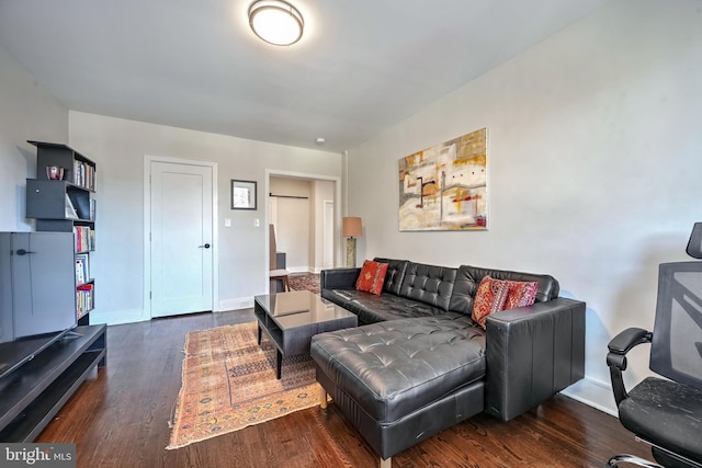 living room with baseboards and wood finished floors