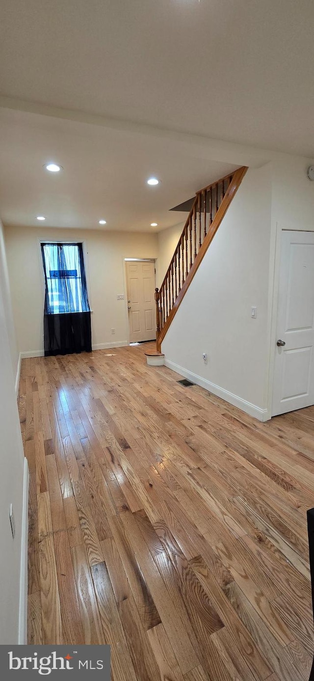 2113 E William St, Philadelphia, PA 19134 - unfurnished living room with baseboards, light wood finished floors, stairs, and visible vents
