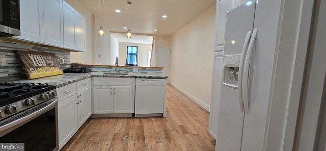 2113 E William St, Philadelphia, PA 19134 - kitchen featuring a sink, decorative backsplash, white cabinetry, and stainless steel appliances