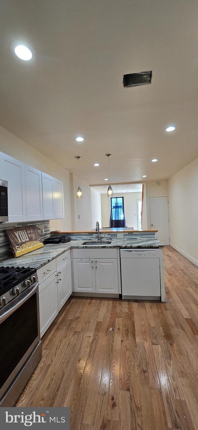 2113 E William St, Philadelphia, PA 19134 - kitchen with stainless steel appliances, recessed lighting, a sink, and wood finished floors