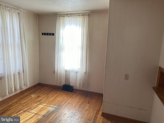 empty room featuring light wood-type flooring and visible vents