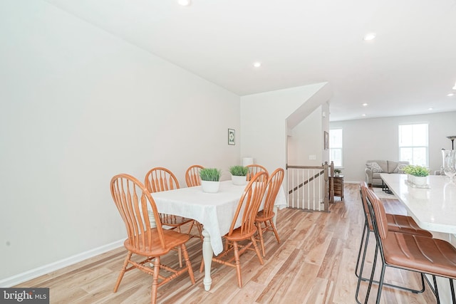 dining area featuring recessed lighting, baseboards, and light wood finished floors