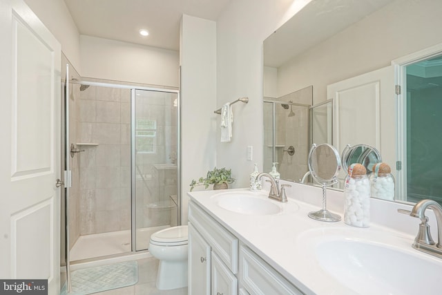 full bath featuring a sink, tile patterned floors, toilet, and a shower stall