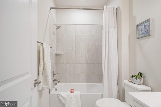 bathroom with vanity, shower / tub combo with curtain, and toilet