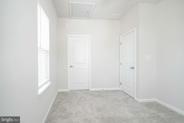 carpeted empty room featuring baseboards and a wealth of natural light