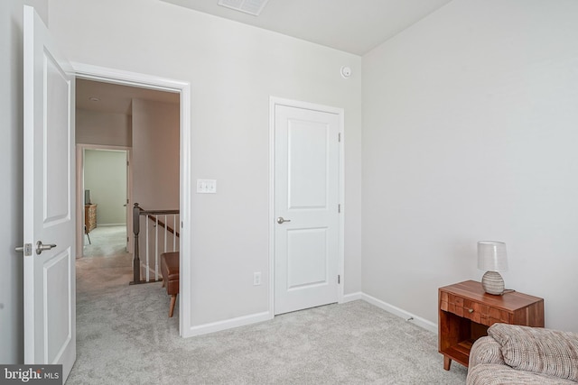 sitting room featuring carpet floors, baseboards, an upstairs landing, and visible vents
