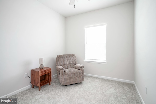 sitting room with carpet flooring, baseboards, and ceiling fan