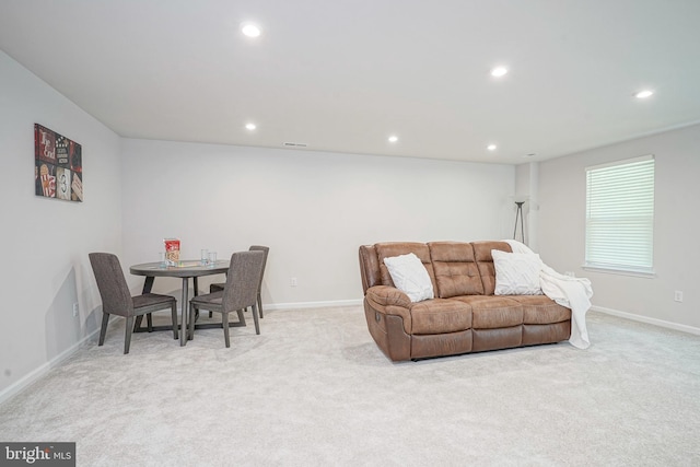 living room with recessed lighting, baseboards, and light carpet
