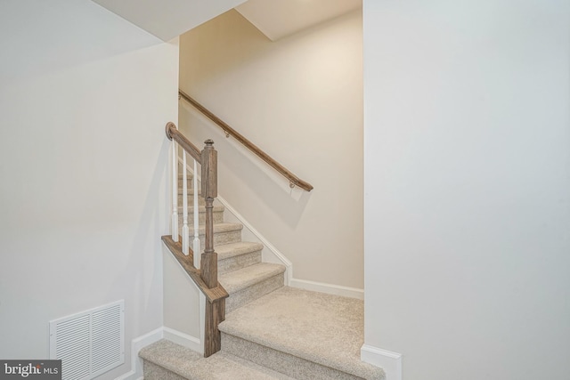 stairs with baseboards, visible vents, and carpet