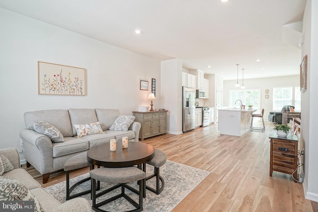 living area featuring recessed lighting and light wood-style flooring