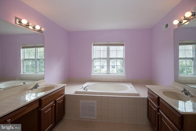 full bathroom featuring a sink, two vanities, and visible vents