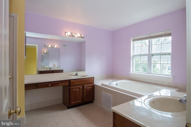 bathroom featuring a garden tub, tile patterned flooring, visible vents, and vanity