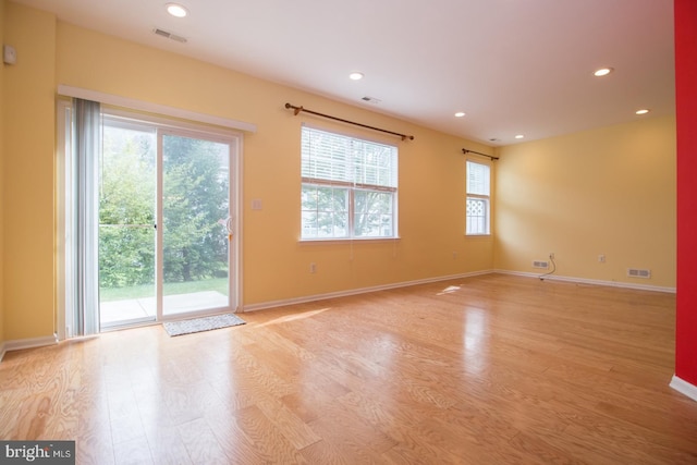 unfurnished room with recessed lighting, visible vents, baseboards, and light wood-type flooring