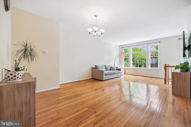 14019 Rockingham Rd, Germantown, MD 20874 - living area featuring light wood-style flooring, a chandelier, and baseboards