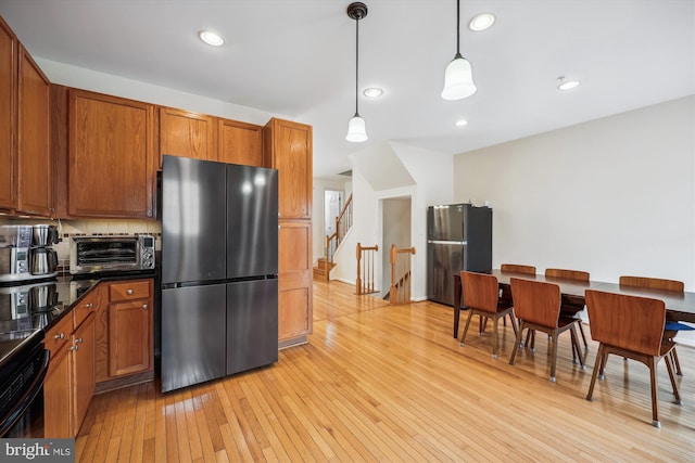 14019 Rockingham Rd, Germantown, MD 20874 - kitchen featuring freestanding refrigerator, dark countertops, and brown cabinetry