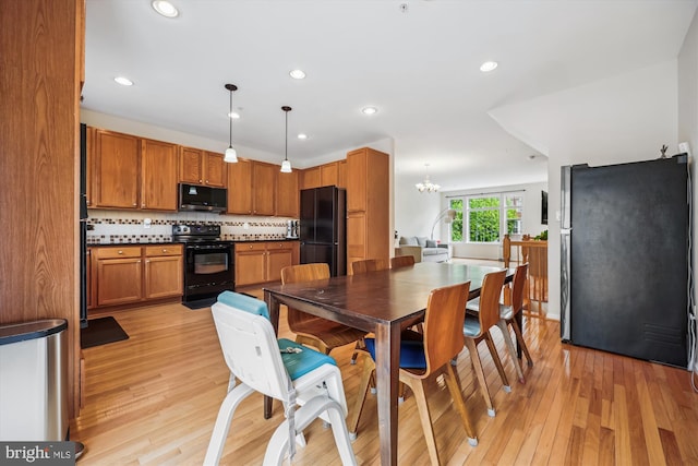 14019 Rockingham Rd, Germantown, MD 20874 - dining room featuring light wood finished floors, a chandelier, and recessed lighting