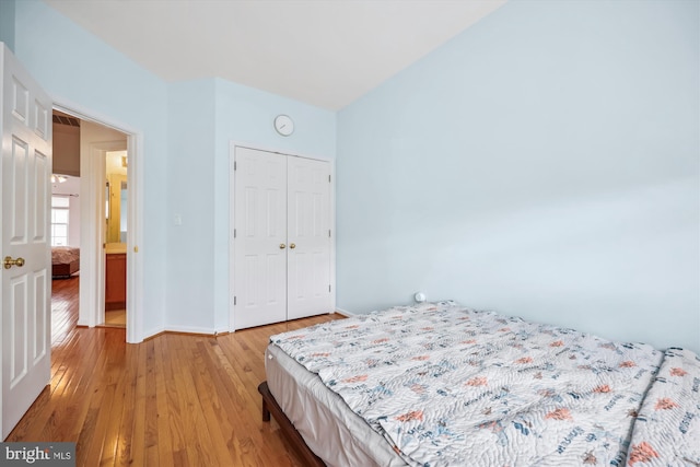 14019 Rockingham Rd, Germantown, MD 20874 - bedroom with light wood-style flooring, a closet, baseboards, and vaulted ceiling