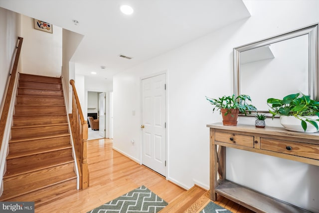 14019 Rockingham Rd, Germantown, MD 20874 - entryway with light wood finished floors, stairway, recessed lighting, and baseboards