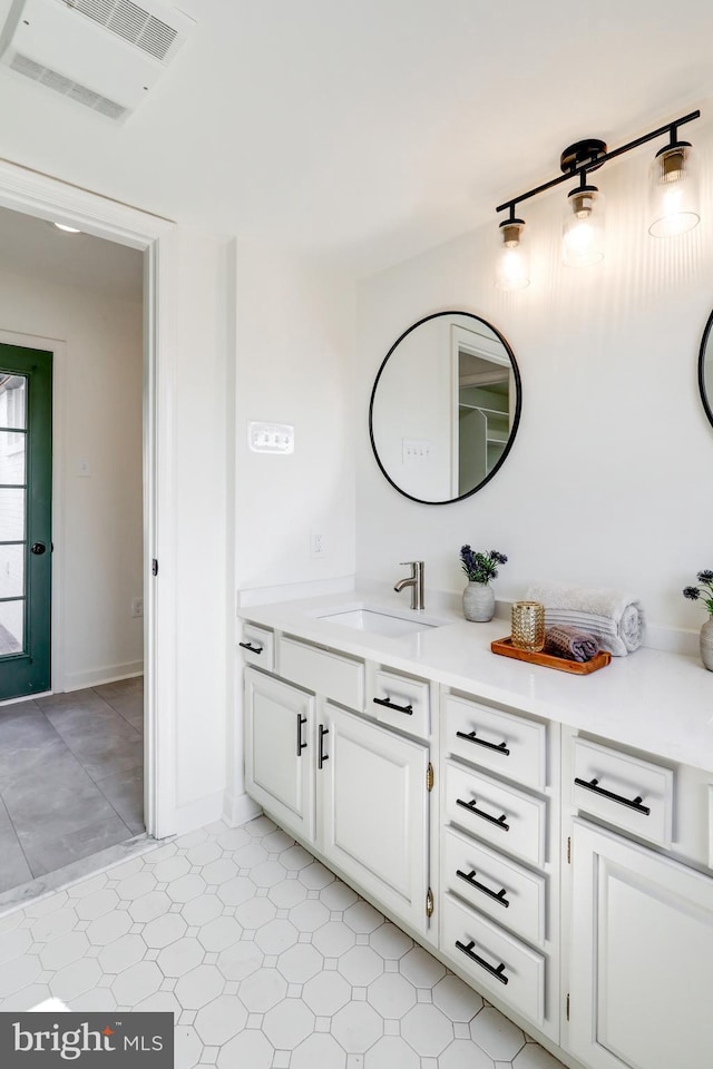 bathroom with tile patterned floors, visible vents, and vanity