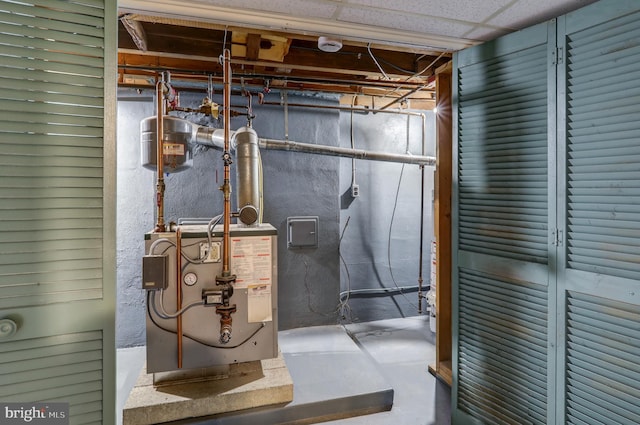 utility room featuring water heater