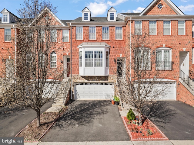 43260 Mitcham Sq, Ashburn, VA 20148 - view of property with brick siding, aphalt driveway, and an attached garage