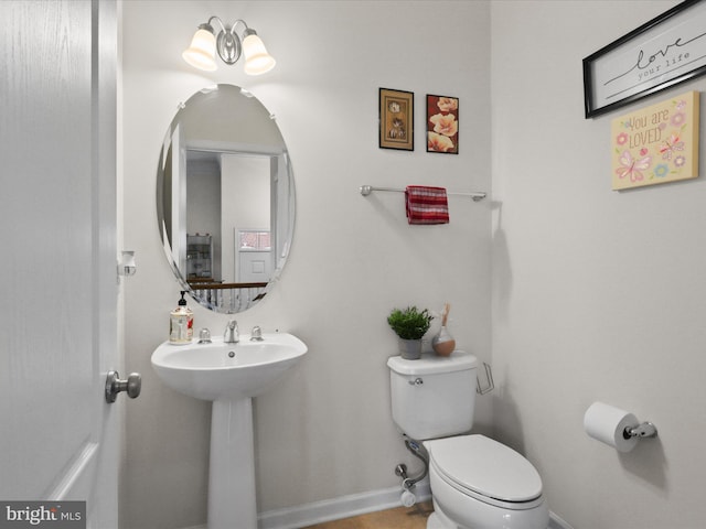 43260 Mitcham Sq, Ashburn, VA 20148 - bathroom with baseboards, toilet, and a sink