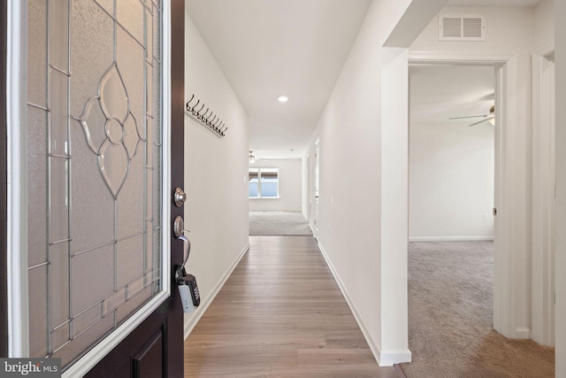corridor with baseboards, light carpet, recessed lighting, and visible vents