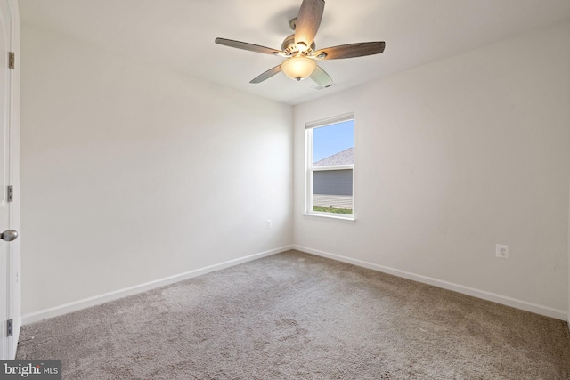 spare room featuring a ceiling fan, baseboards, visible vents, and carpet