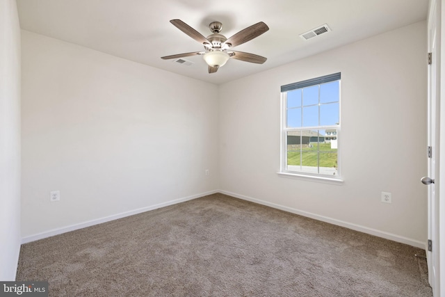 spare room featuring baseboards, a ceiling fan, carpet flooring, and visible vents
