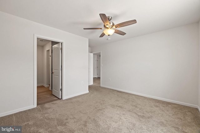 unfurnished bedroom with carpet floors, baseboards, and ceiling fan