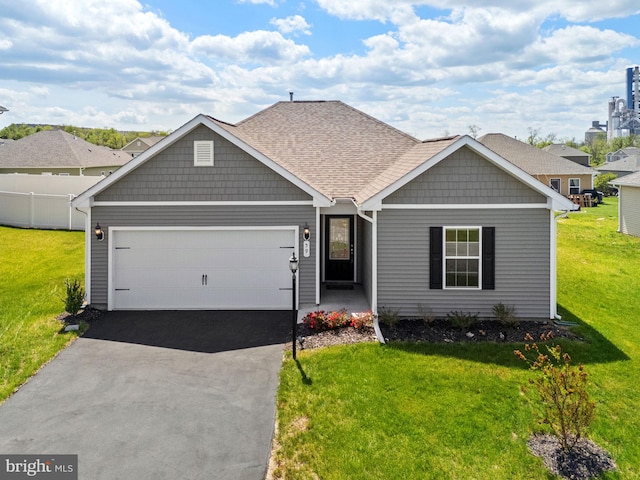 craftsman-style house with an attached garage, a front lawn, and driveway