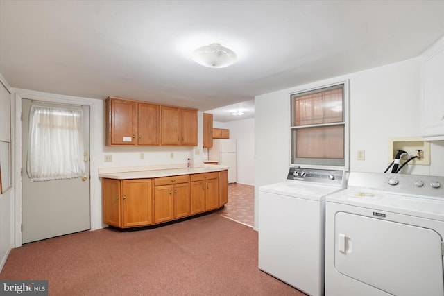 washroom featuring light colored carpet, cabinet space, and independent washer and dryer