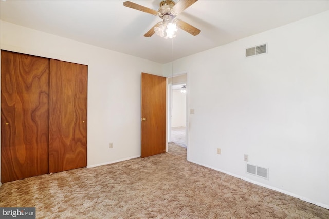 unfurnished bedroom with visible vents, carpet, baseboards, and a closet