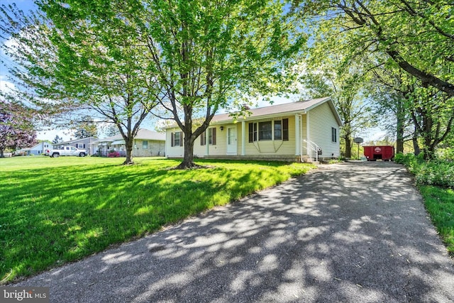 view of front of property with driveway and a front yard