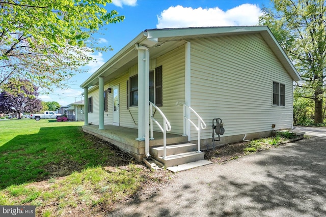 view of side of home with a lawn