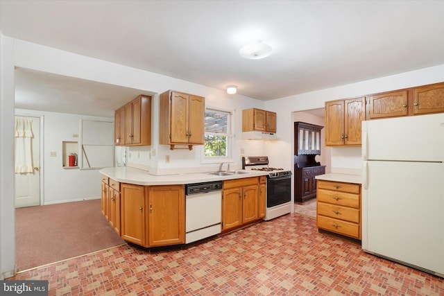 kitchen featuring brown cabinets, a sink, white appliances, light countertops, and under cabinet range hood