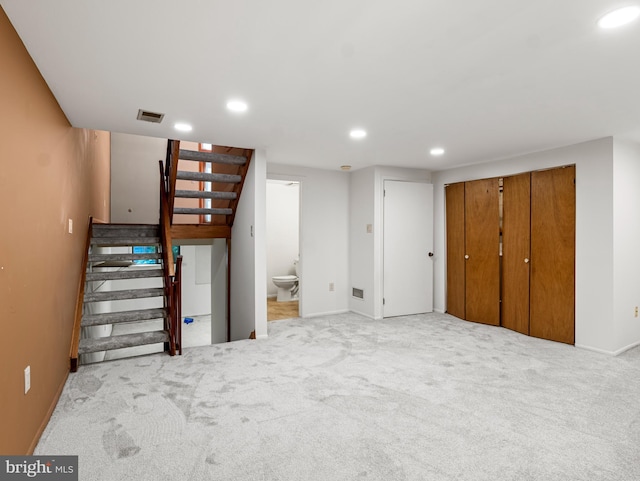 finished below grade area with recessed lighting, stairs, carpet floors, and baseboards