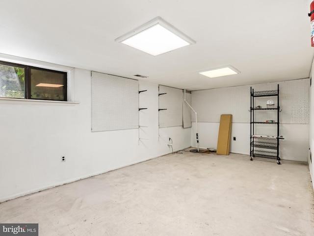 unfurnished room with unfinished concrete flooring