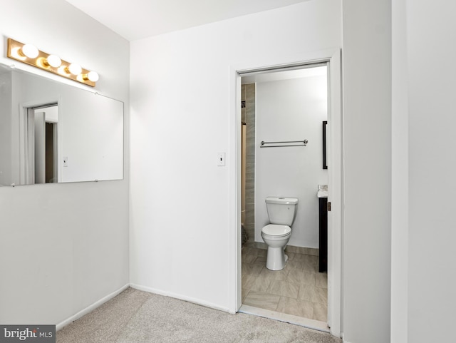 bathroom featuring toilet and baseboards