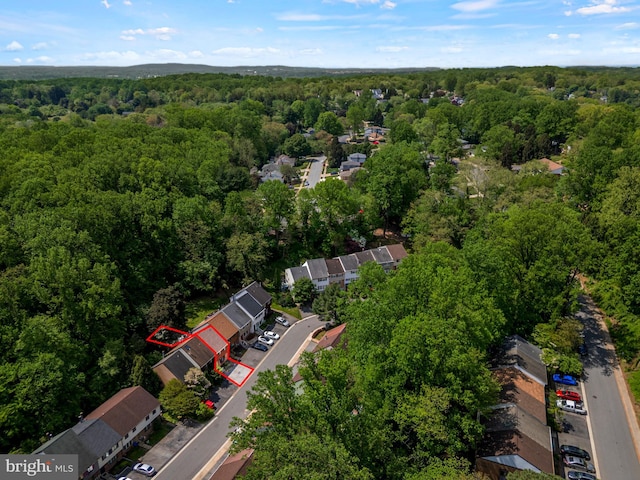 drone / aerial view featuring a wooded view