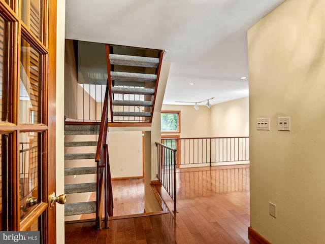 stairs with recessed lighting, baseboards, and hardwood / wood-style flooring