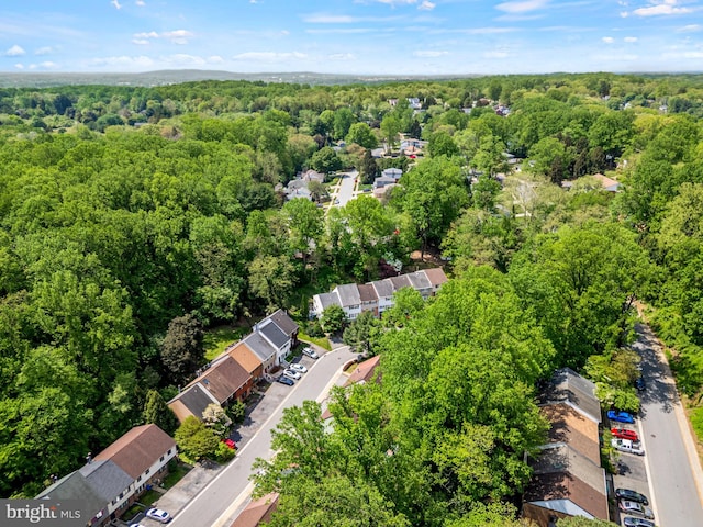 drone / aerial view with a wooded view