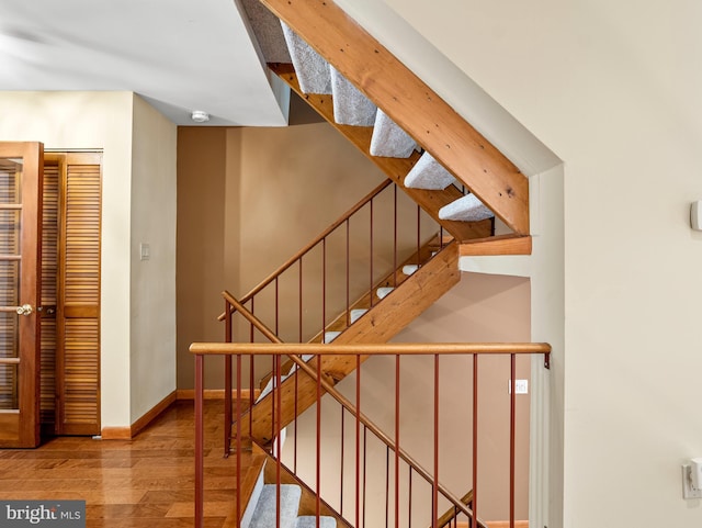 stairs with baseboards and hardwood / wood-style floors