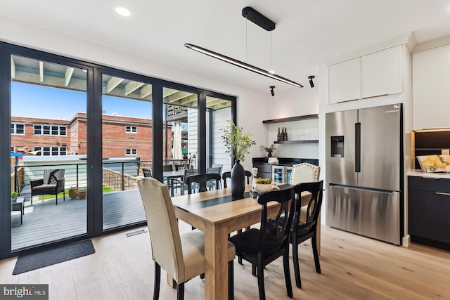dining space featuring light wood finished floors and recessed lighting